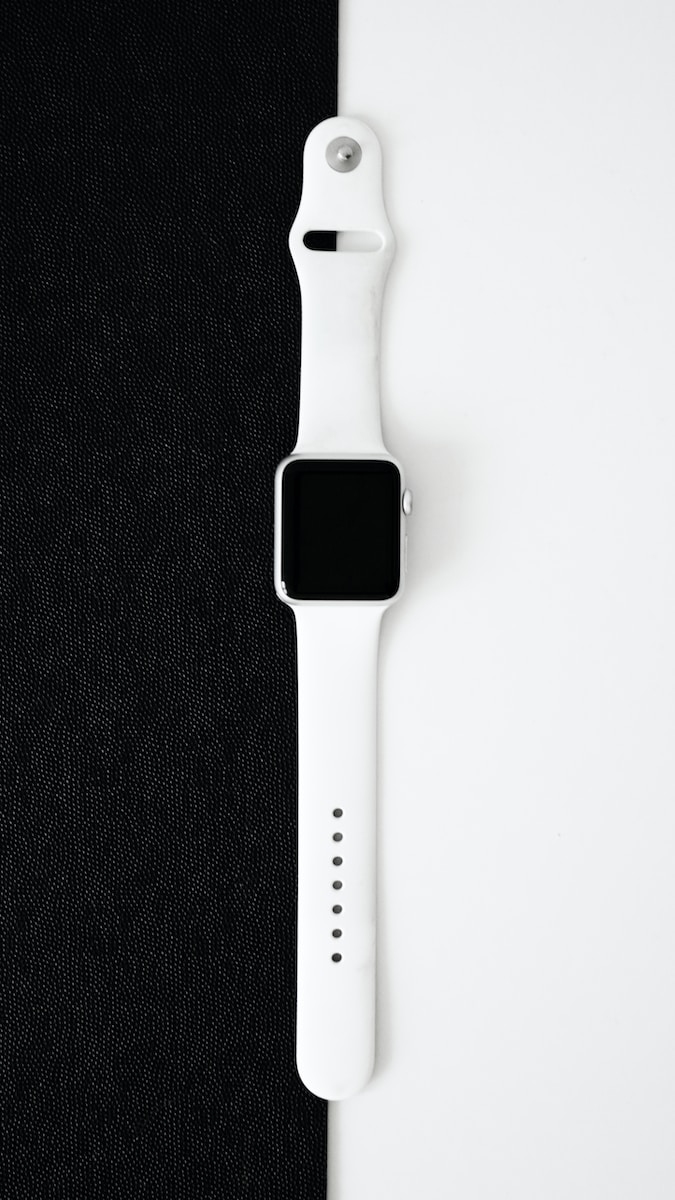 an apple watch sitting on top of a black cloth