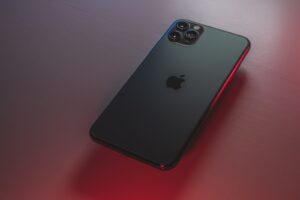 black iphone 7 plus on red table