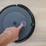 Person Pointing on Black Vacuum Cleaner