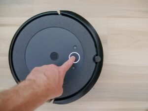 Person Pointing on Black Vacuum Cleaner