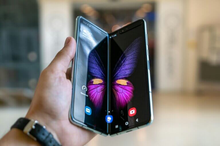 person holding black foldingphone